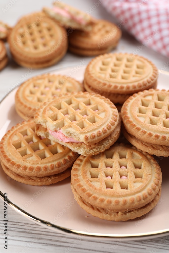 Tasty sandwich cookies with cream on white wooden table, closeup Tasty sandwich cookies with cream on white wooden table, closeup