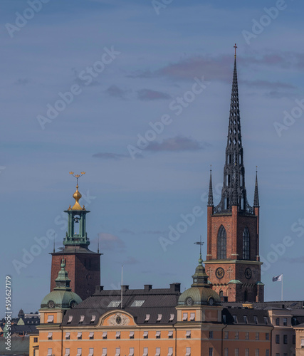 Church spire and tower of the Town City Hall roofs and facades of court buildings on the island Riddarholmen, a sunny spring day in Stockholm