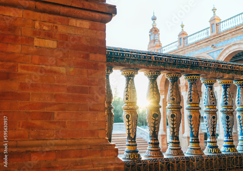 The Plaza de España galleries lited up with evening sunlight. Painted balusters view on Spain Square, Andalusia, South Spain. photo