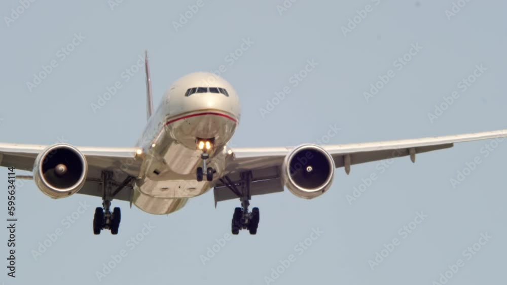 Airplane landing overhead at Canadian airport. Passenger flight arriving and descending. Front bottom view of aircraft flies and approaching. Airplane landing overhead at Canadian airport. Passenger flight arriving and descending. Front bottom view of aircraft flies and approaching.