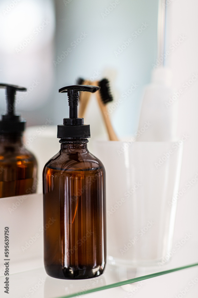 hygiene, beauty and daily routine concept - close up of lotion, toothbrush and toothpaste on mirror shelf in bathroom hygiene, beauty and daily routine concept - close up of lotion, toothbrush and toothpaste on mirror shelf in bathroom