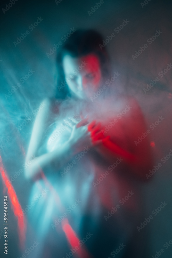 Air pollution. Toxic smog. Environment contamination. Climate disaster. Red blue color light defocused exhausted suffering woman silhouette in smoke cloud.