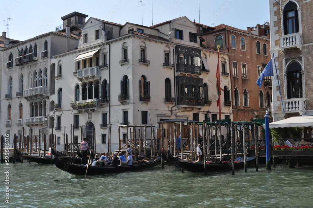 a magical Venetian street with tiny houses and canals with the sea