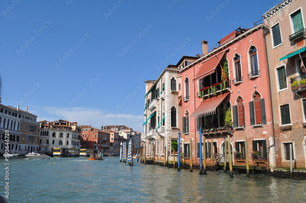 a magical Venetian street with tiny houses and canals with the sea