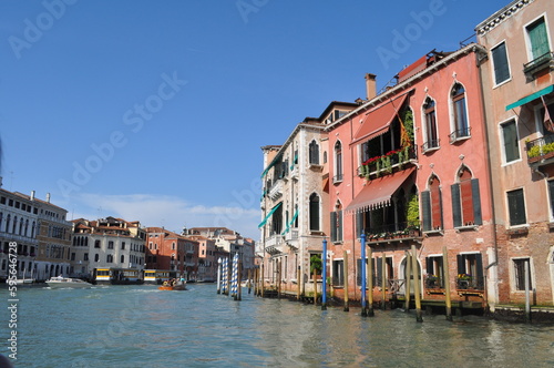 a magical Venetian street with tiny houses and canals with the sea