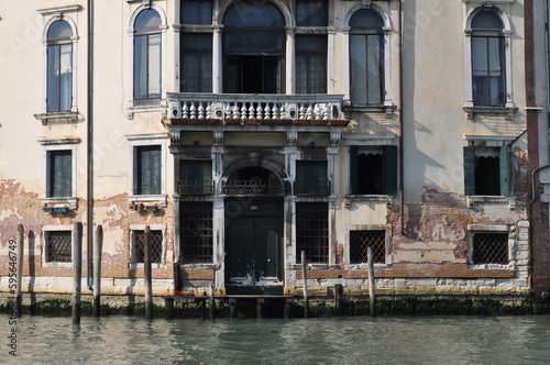 a magical Venetian street with tiny houses and canals with the sea