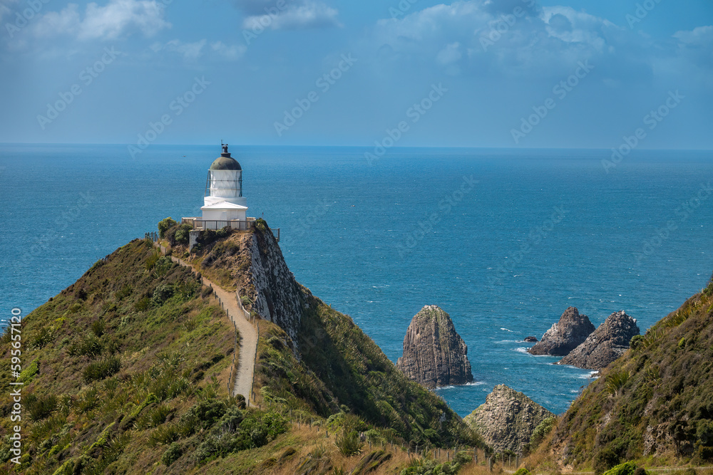 Nugget Point (Tokata). Iconic promontory on the Otago coast, the Catlins, South Island, New Zealand. Crowned by a lighthouse surrounded by rocky islets. 
