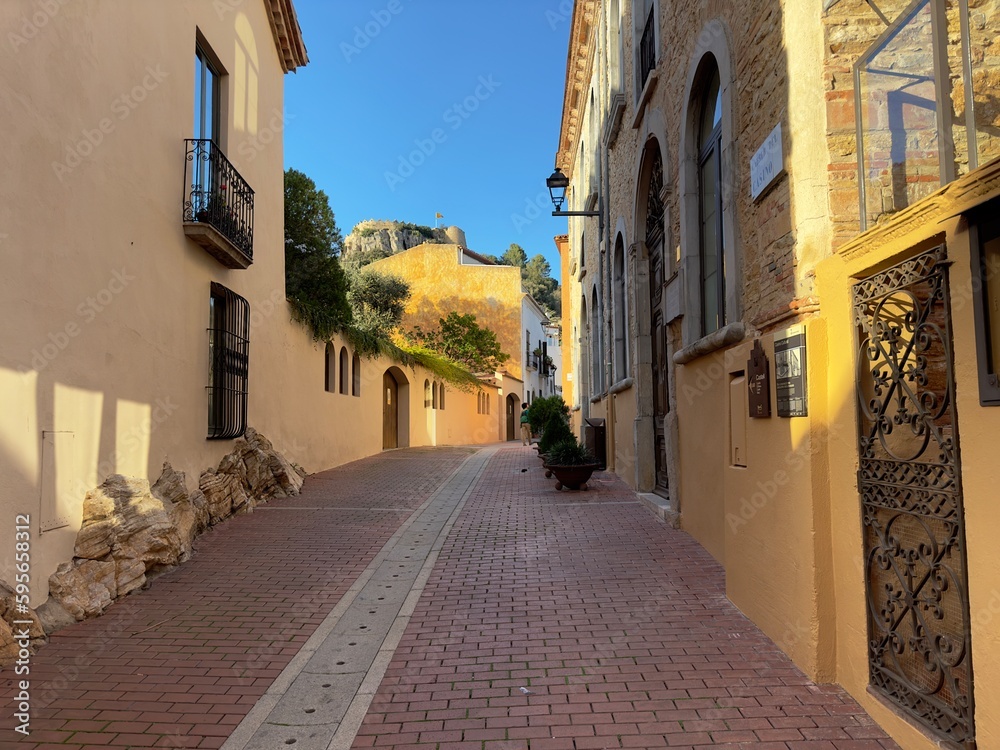 View through an alley in the old town of Begur in the evening light, Catalonia, Spain