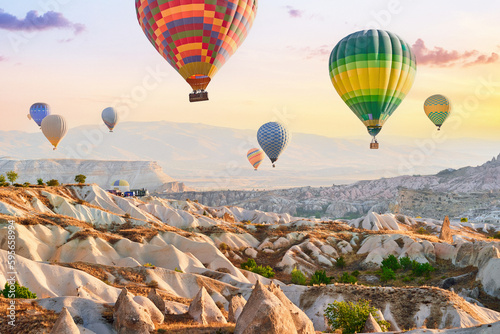 Landscape of scenic valley with colorful flying hot air balloons in Anatolia, Kapadokya. Beautiful destination in Nevsehir, Goreme