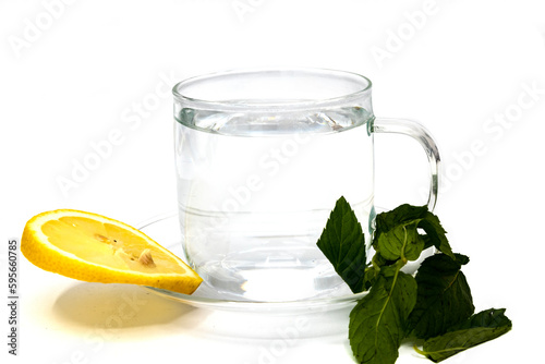 Cup of tea and mint with limon on a white background. Broown sugar