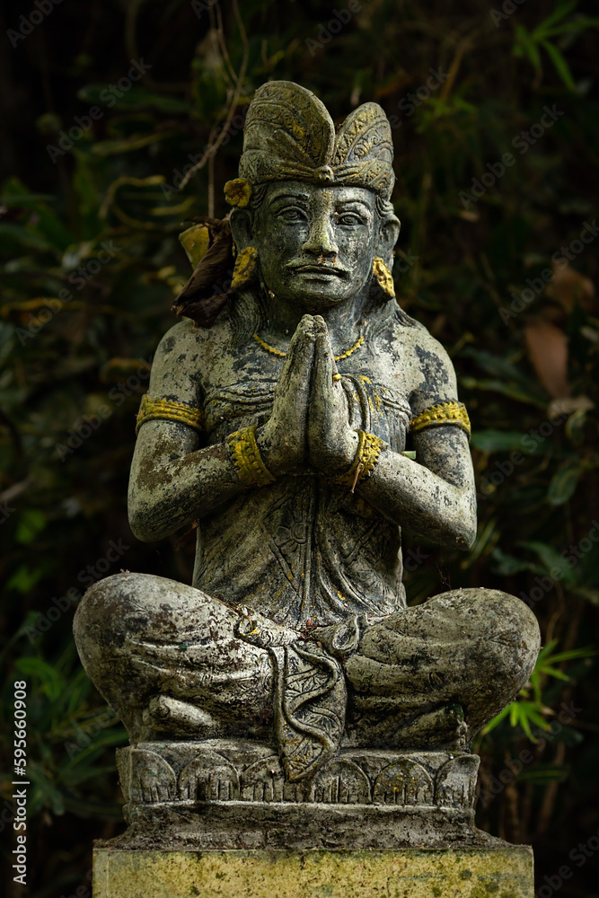 Stone statue on a dark background. Bali. Indonesia
