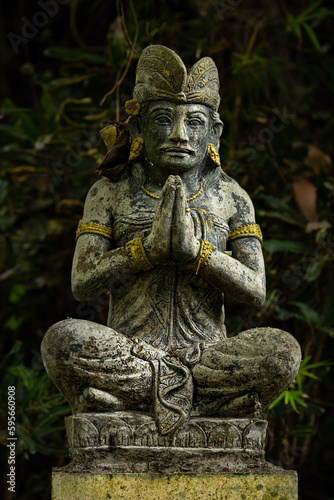 Stone statue on a dark background. Bali. Indonesia