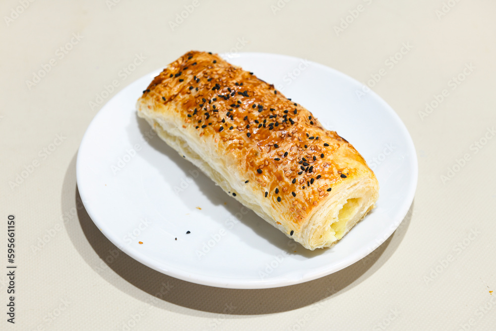 Turkish style meat stuffed filo dough borek served kol boregi. Cheese and minced pie are sliced on a marble background. Turkish name: Kol Boregi, ispanakli, kiymali, Su Boregi Turkish style meat stuffed filo dough borek served kol boregi. Cheese and minced pie are sliced on a marble background. Turkish name: Kol Boregi, ispanakli, kiymali, Su Boregi