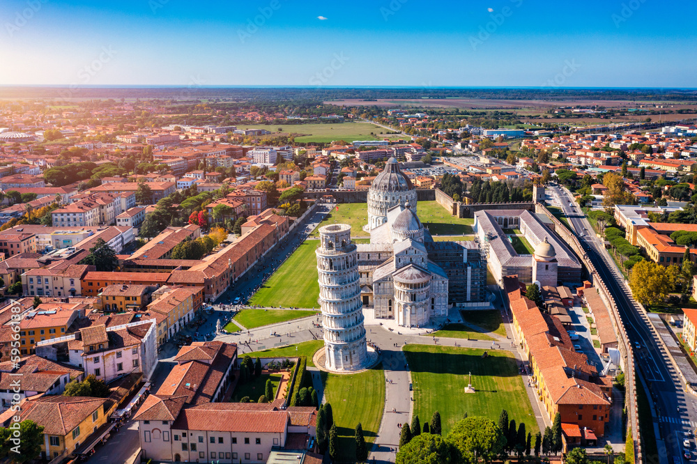Fototapeta premium Pisa Cathedral and the Leaning Tower in a sunny day in Pisa, Italy. Pisa Cathedral with Leaning Tower of Pisa on Piazza dei Miracoli in Pisa, Tuscany, Italy.