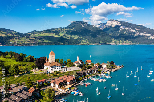 View of Spiez Church and town on the shore of Lake Thun in the Swiss canton of Bern at sunset, Spiez, Switzerland. Spiez city on lake Thun in the canton of Bern, Switzerland. photo