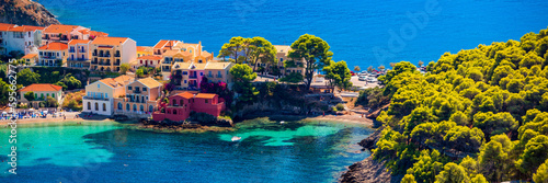 Assos village in Kefalonia, Greece. Turquoise colored bay in Mediterranean sea with beautiful colorful houses in Assos village in Kefalonia, Greece, Ionian island, Cephalonia, Assos village.