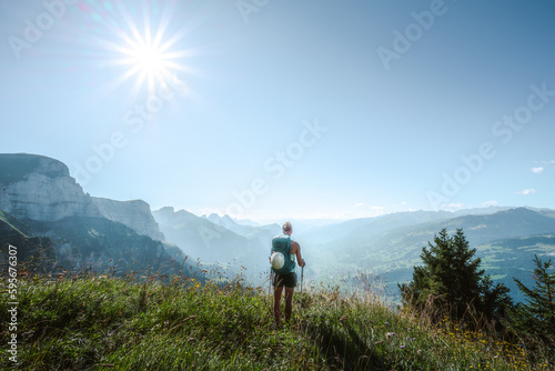 Athletic woman enjoys the view from a vantage point on the Walensee in the morning. Schnürliweg, Walensee, St. Gallen, Switzerland, Europe. © Michael