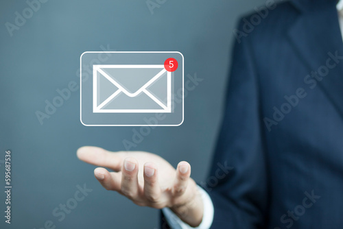 Businessman hand holding e-mail icon, Contact us by newsletter email