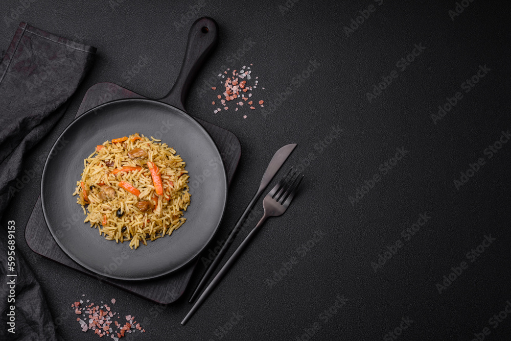 Delicious Uzbek pilaf with chicken, carrots, barberry, spices and herbs - obrazy, fototapety, plakaty 