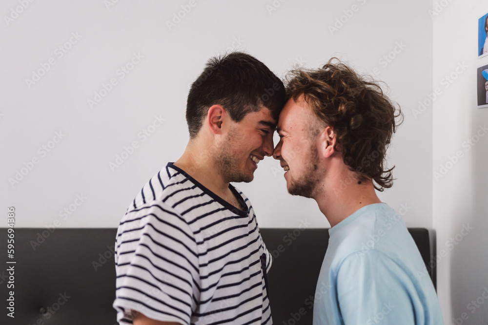 Happy gay couple standing close to each other Happy gay couple standing close to each other