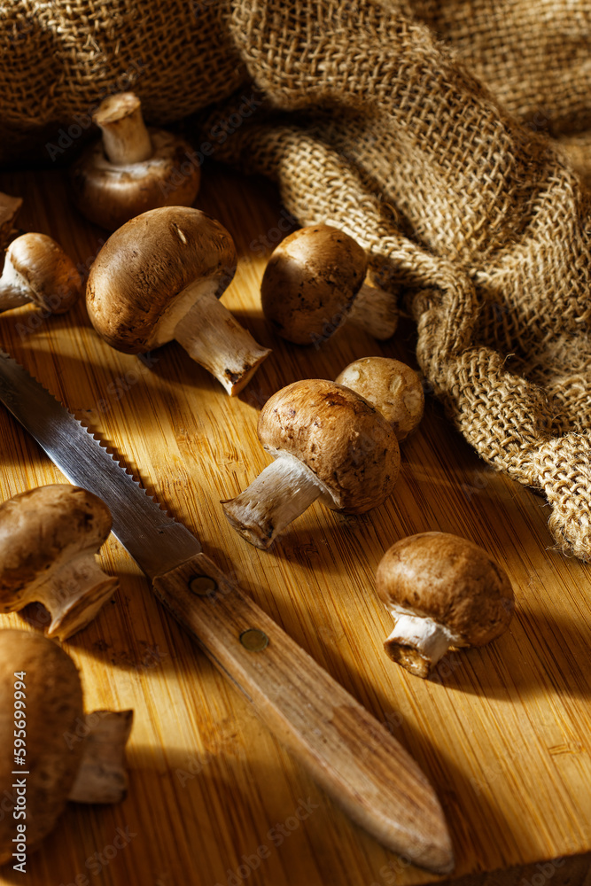 Close up of brown mushrooms on a wooden board Close up of brown mushrooms on a wooden board