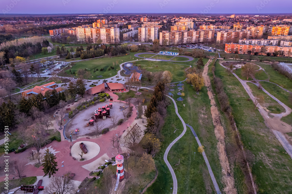 Φωτογραφία Suburban playground with wooden toys and council estate houses in Szombathely, H
