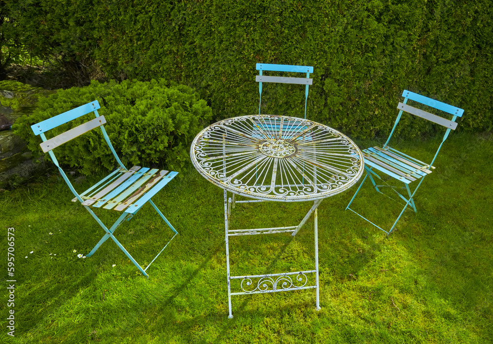 Beautiful old garden furniture with decoration in an idyllic garden. Beautiful old garden furniture with decoration in an idyllic garden.