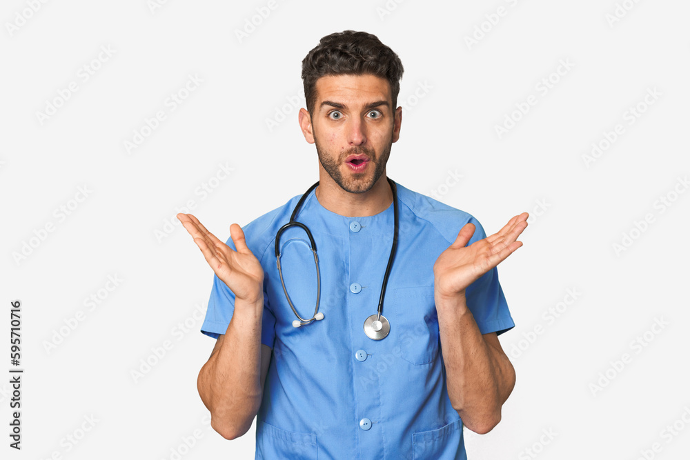Young nurse man surprised and shocked. Young nurse man surprised and shocked.