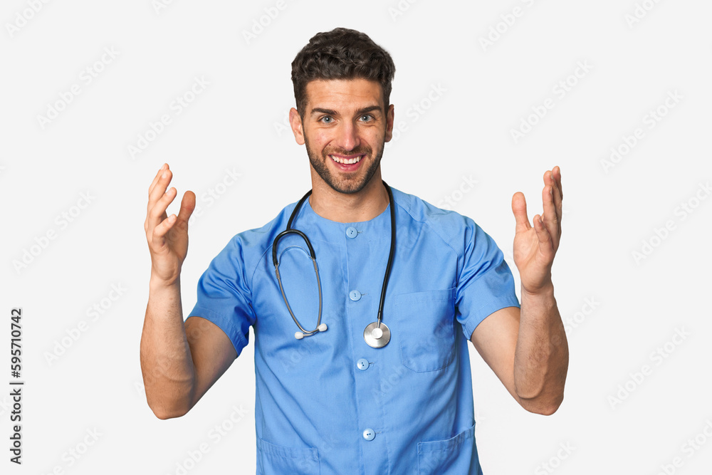 Young nurse man receiving a pleasant surprise, excited and raising hands. Young nurse man receiving a pleasant surprise, excited and raising hands.