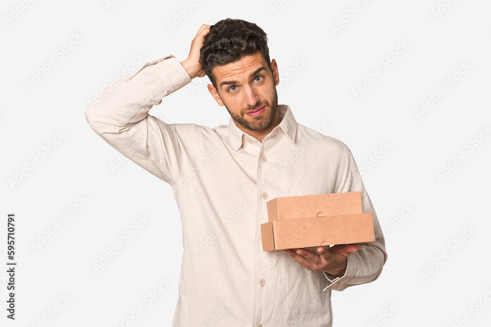 Young man holding a takeaway boxes isolated being shocked, she has remembered important meeting. Young man holding a takeaway boxes isolated being shocked, she has remembered important meeting.