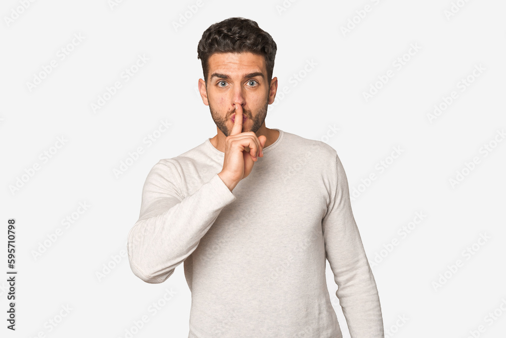 Young handsome man isolated keeping a secret or asking for silence.