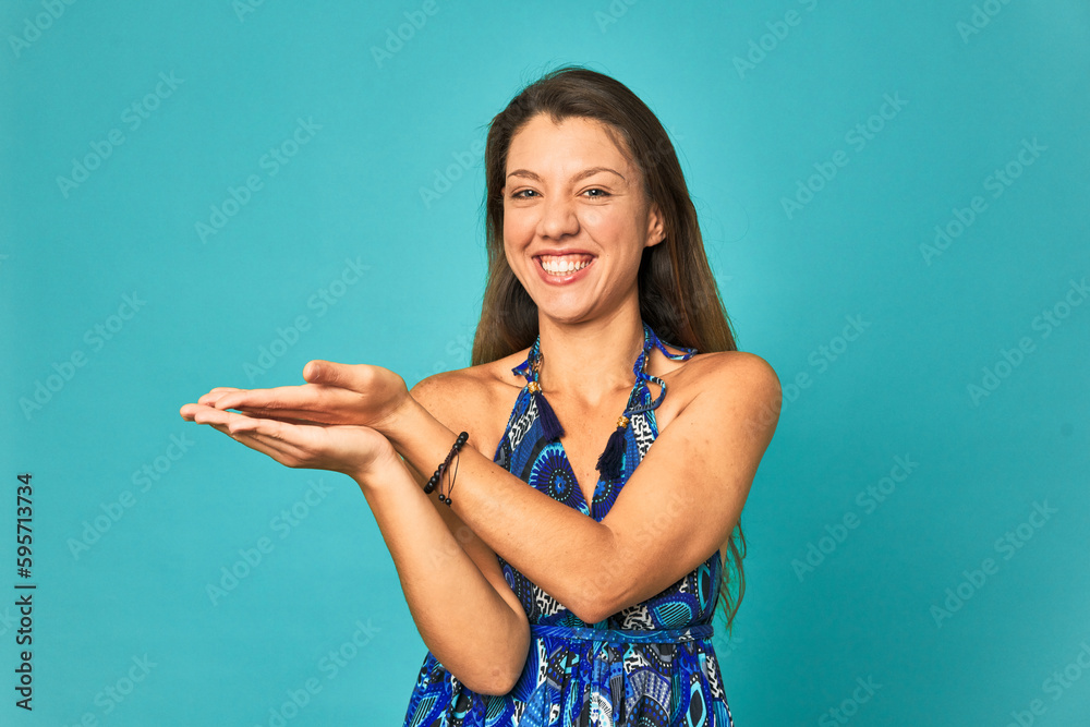 Fototapeta premium A young caucasian woman isolated holding a copy space on a palm.