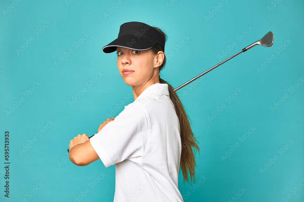 Stylish young woman playing golf in studio Stylish young woman playing golf in studio