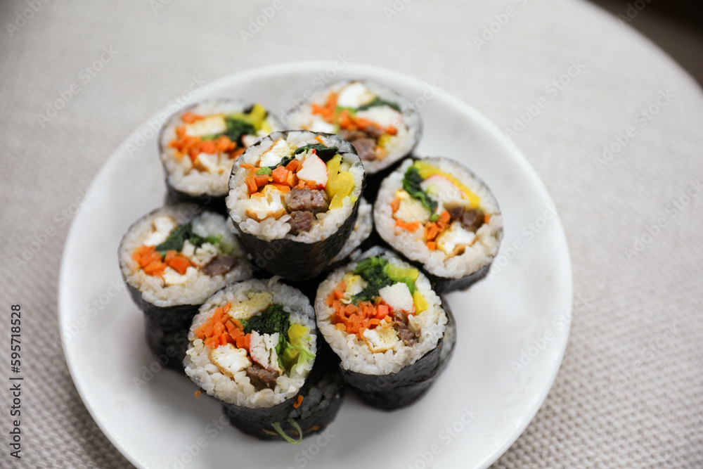Kimbap is a traditional Korean dish made of rice, vegetables, and meat or seafood rolled in seaweed. It represents the country's rich culinary heritage and cultural diversity Kimbap is a traditional Korean dish made of rice, vegetables, and meat or seafood rolled in seaweed. It represents the country's rich culinary heritage and cultural diversity