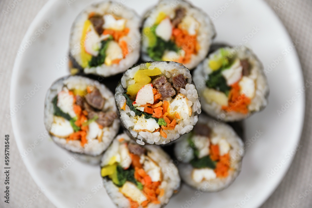 Kimbap is a traditional Korean dish made of rice, vegetables, and meat or seafood rolled in seaweed. It represents the country's rich culinary heritage and cultural diversity
