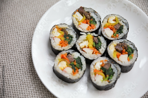 Kimbap is a traditional Korean dish made of rice, vegetables, and meat or seafood rolled in seaweed. It represents the country's rich culinary heritage and cultural diversity