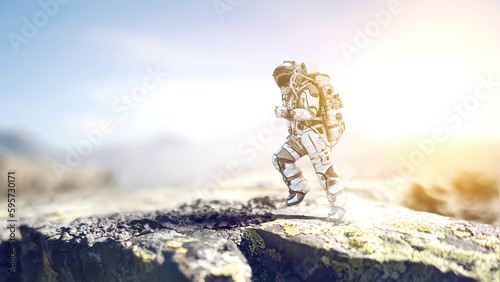 Astronaut walking on an unexplored planet photo