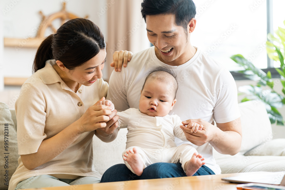Smiling mother and father holding newborn son at home Smiling mother and father holding newborn son at home
