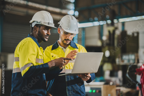 professional technician engineer with safety helmet hard hat working in industrial manufacturing factory, men at work to checking equipment of machinery production technology or construction operating photo