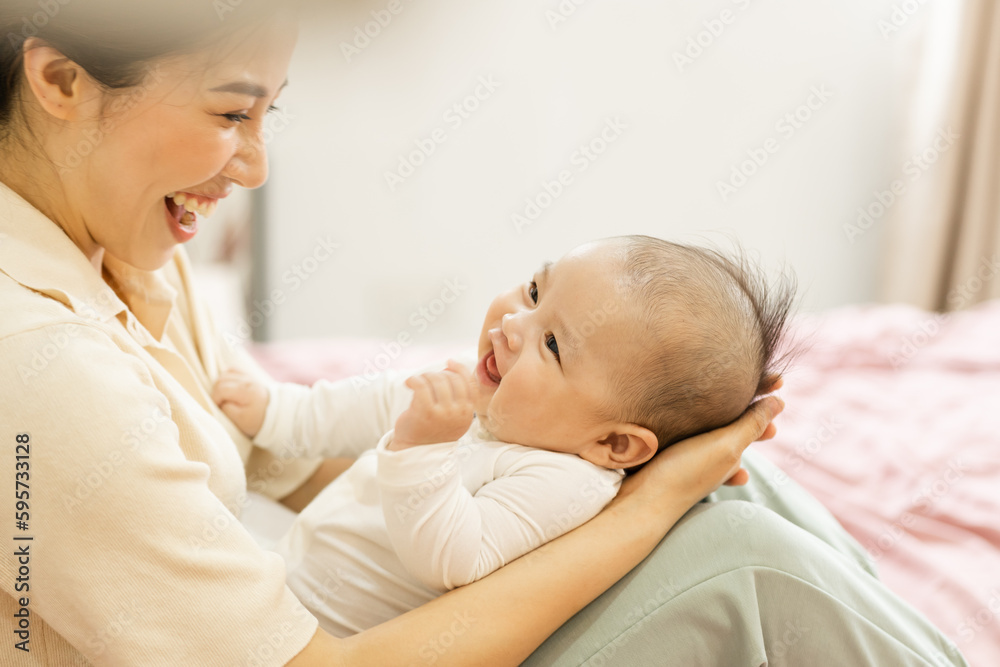 Asian mother and newborn baby feet are smiling and happy Asian mother and newborn baby feet are smiling and happy