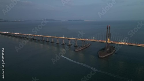 Aerial iew a boat move at Penang Bridge in twilight hour photo