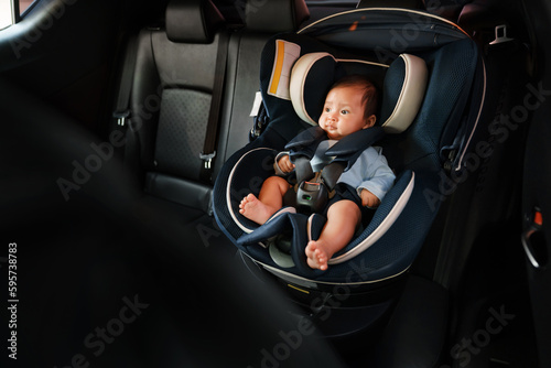 newborn baby sitting in infant car seat, safety chair travelling © geargodz