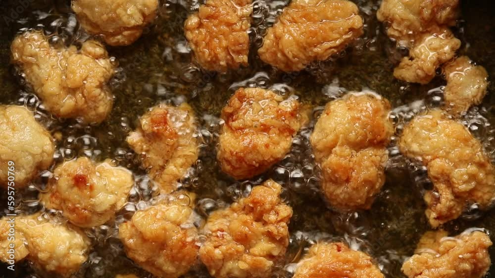 Top view of Crispy Popcorn Chicken are Fried in Boiling Oil Top view of Crispy Popcorn Chicken are Fried in Boiling Oil