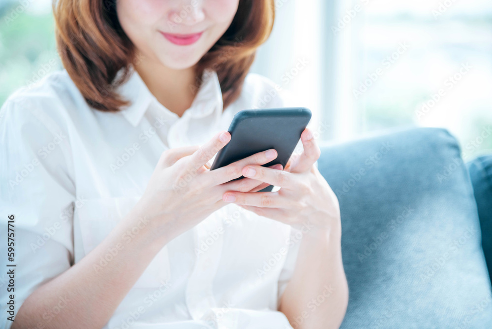 Asian woman holding smartphone with E-commerce Shopping online website Reading Online Article, Blog, vlog. Young Woman hands holding phone technology lifestyle. Happy Woman using digital smart phone Asian woman holding smartphone with E-commerce Shopping online website Reading Online Article, Blog, vlog. Young Woman hands holding phone technology lifestyle. Happy Woman using digital smart phone