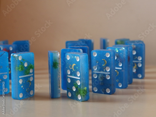Handmade domino blue with gold on beige background