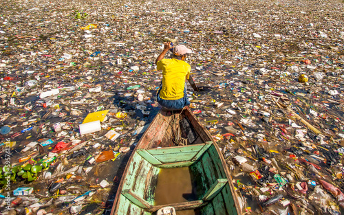 People collect trash that can be recycled and traded from the sea of garbage in the Citarum River, Bandung, Wes Java. Citarum River is the one of polluted river in Indonesia. 