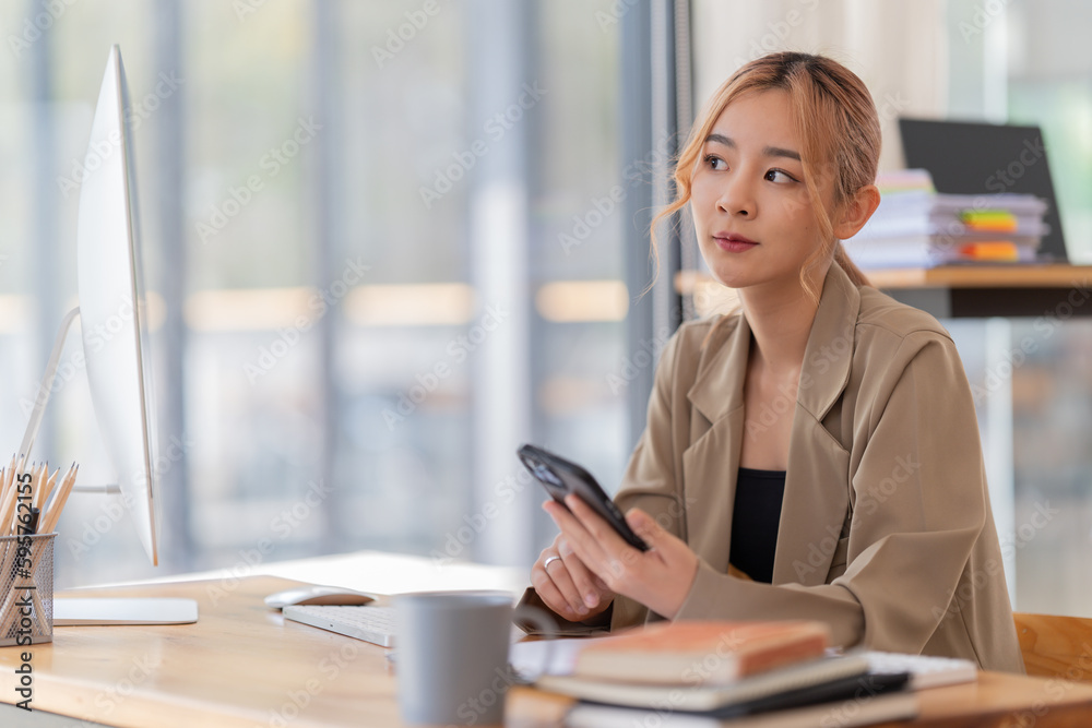 appy young businesswoman Asian siting on the chairs cheerful demeanor raise holding coffee cup smiling looking laptop screen .Making opportunities female working successful in the office. appy young businesswoman Asian siting on the chairs cheerful demeanor raise holding coffee cup smiling looking laptop screen .Making opportunities female working successful in the office.