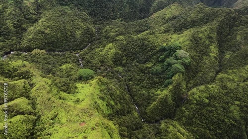 Stunning aerial view of the spectacular green mountains and waterfalls of rainforest in Kauai , Hawaii, United States.Incredible nature landscape. View from a helicopter photo