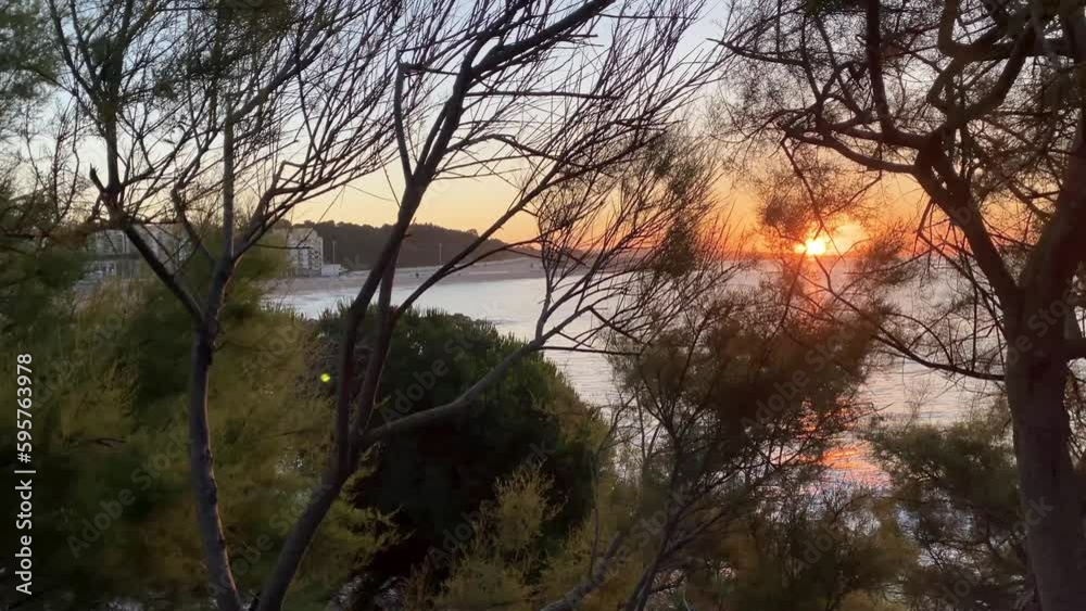 beautiful sundown over a road with traffic passing by, while the waves crash onto the shore, and the lens flare adds a touch of magic to the scene beautiful sundown over a road with traffic passing by, while the waves crash onto the shore, and the lens flare adds a touch of magic to the scene