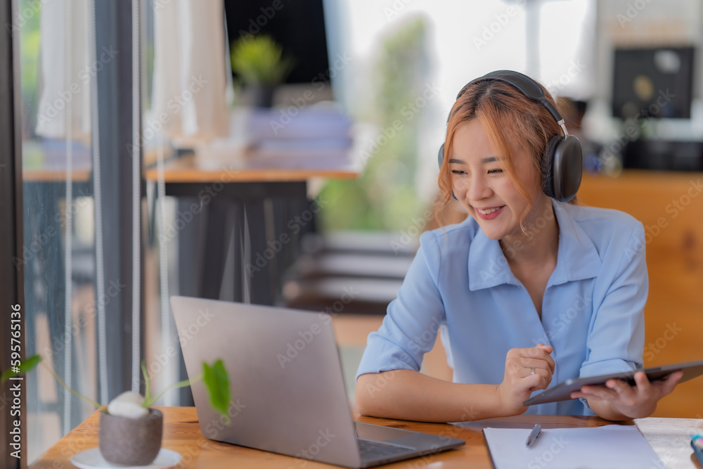 Young student who learns with online platform at coffee shop or co-working space Young student who learns with online platform at coffee shop or co-working space